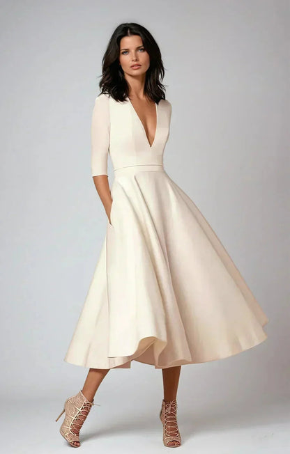 Robe midi évasée col en V, manches 3/4, en tissu lisse, avec poches pratiques, idéale pour un mariage.