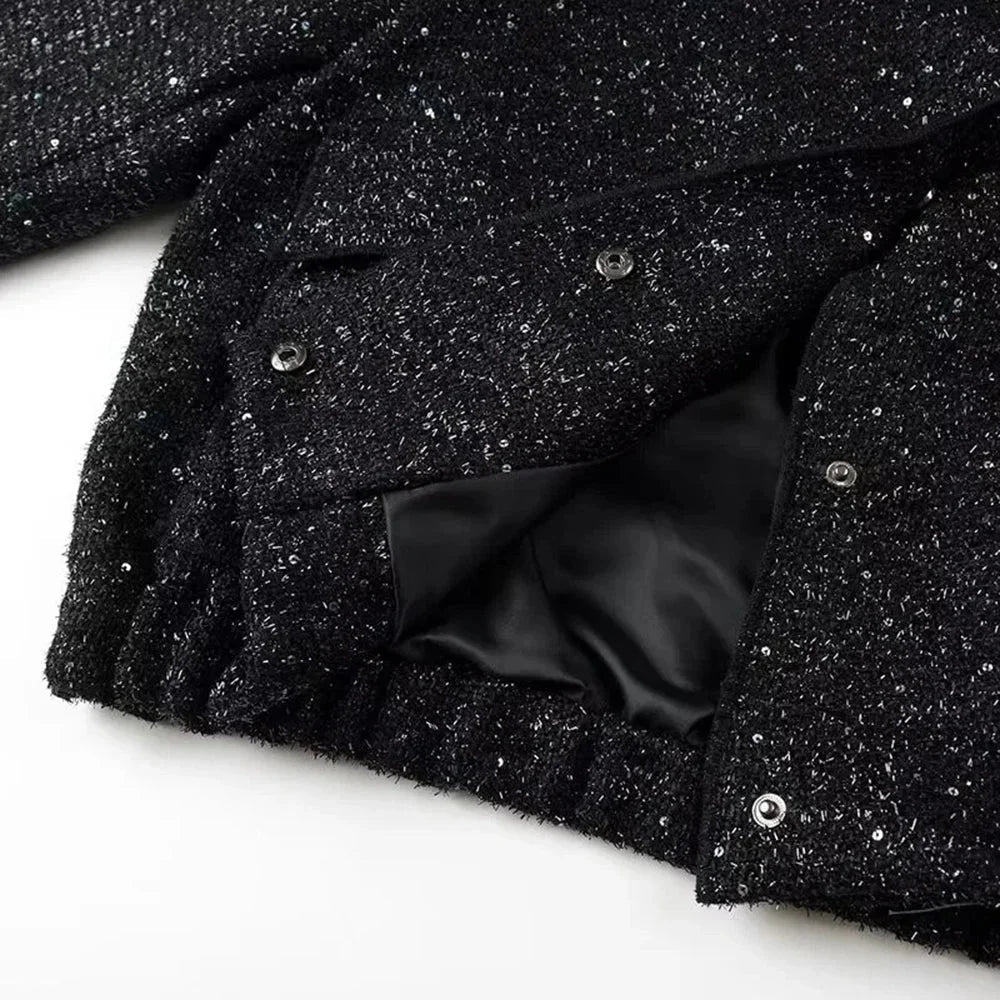 Veste femme à paillettes brillantes, coupe élégante, conçue pour des occasions spéciales.